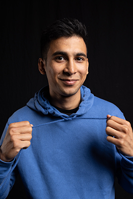 Mohammad smiling in blue hoodie
