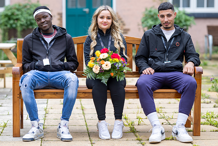 Samuel Oluwagbenga Friendship Bench with 3 x Uxbridge students sitting on it remembering him