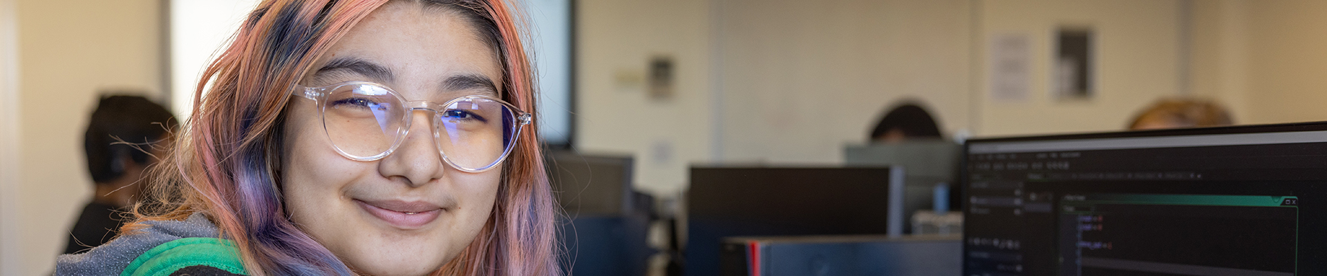 Female Computing student at Uxbridge College smiling at the camera