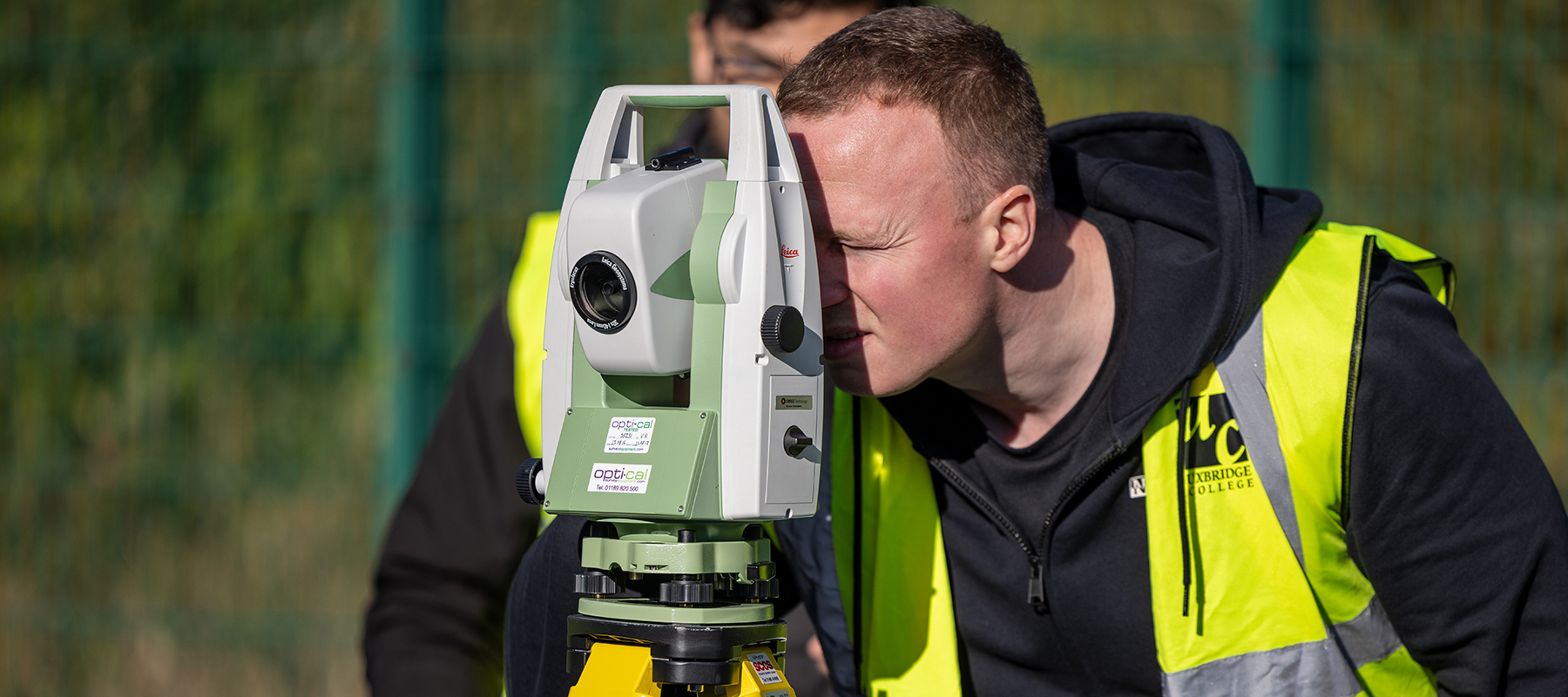 2 x Uxbridge Students from Building Services practicing surveying 