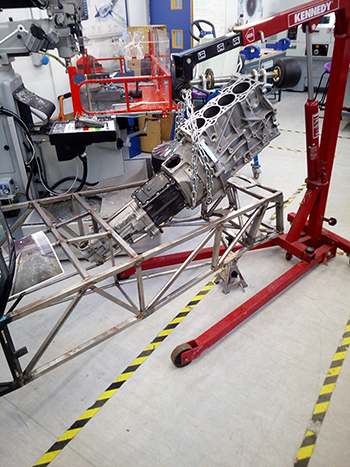 Crane lifting the engine into the car frame for the F1 in Schools H-Rock racing car.