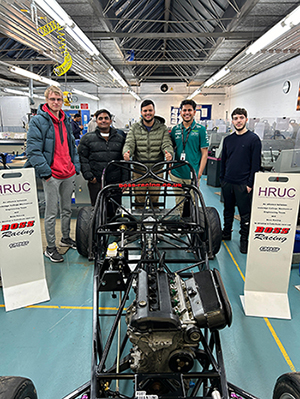 Our proud H-Rock F1 in Schools Team standing in front of their racing car 