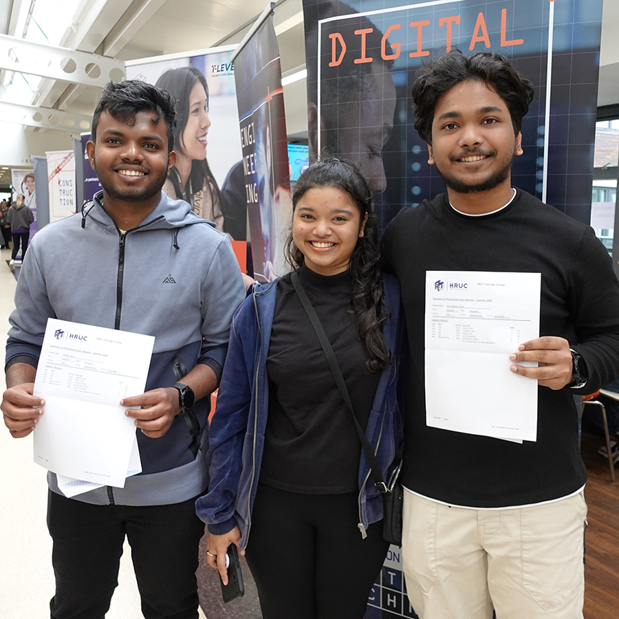 3 Uxbridge College students showing their GCSE results and looking very pleased.