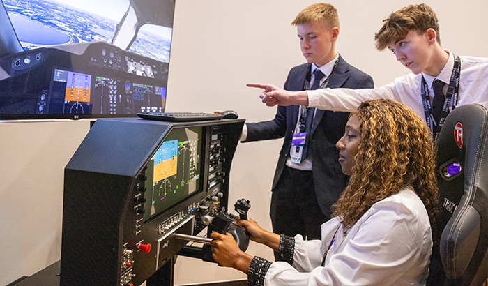 Students from the Heathrow Employment and Skills Academy using the flight simulator