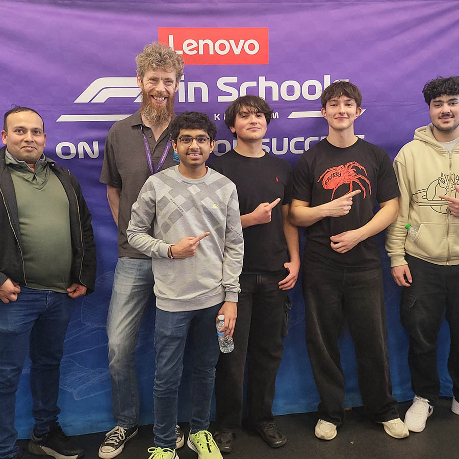 Our Uxbridge College Engineering students F1 in Schools Team and College staff posing for a photo in front of the Lenovo purple banner.